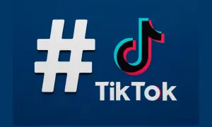 Biały symbol # obok logo TikTok. Zastanawiasz się, jakie hashtagi na Tik Tok wybrać, by zdobyć popularność?