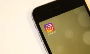 Na ekranie telefonu widoczny jest symbol Instagrama. Zastanawiasz się, czy na IG widać kto odwiedza profil?