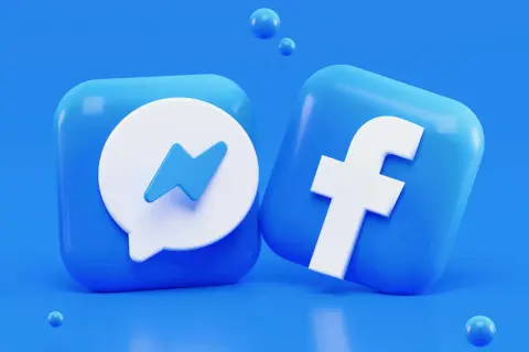 Ikony Facebook i Messenger na niebieskim tle.